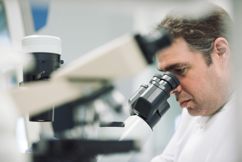 A scientist using a microscope