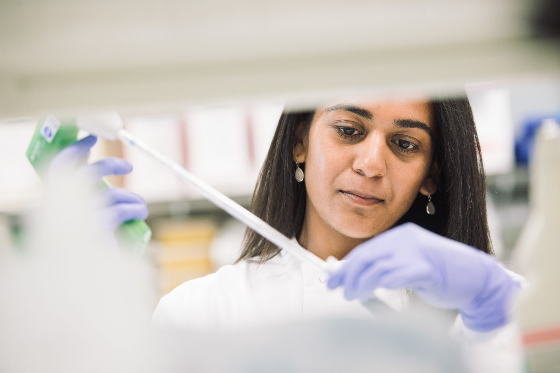 A scientist using a pipette