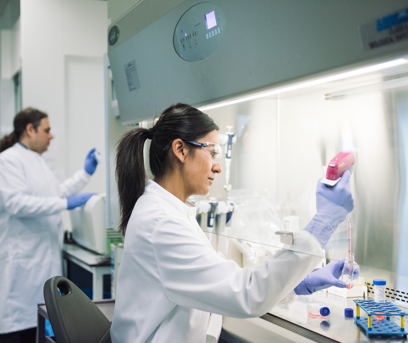 A scientist using a pipette